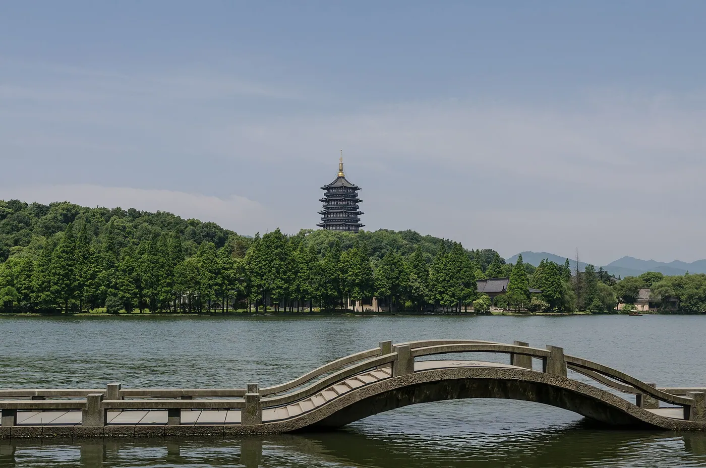 Traditional boat on Hangzhou West Lake under clear daytime light